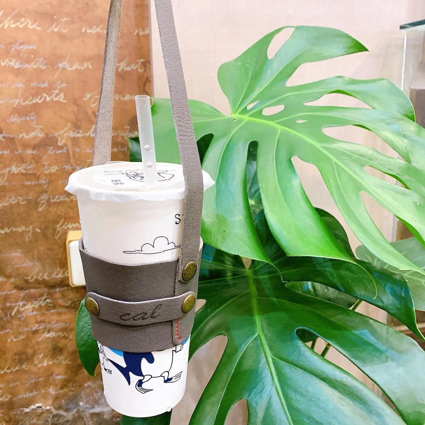 雷雕 cat 字樣的皮革飲料提袋